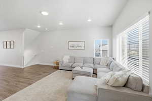 Living area with wood finished floors and recessed lighting