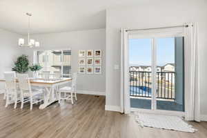 Dining area with light wood finished floors and a chandelier