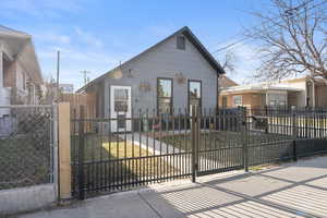 View of front facade with a gate and a fenced front yard