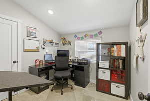 Office area or Bedroom with vaulted ceiling and light colored carpet