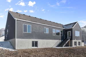 Rear view of house with stairway and roof with shingles