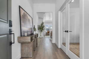 Hall featuring hardwood / wood-style flooring and baseboards