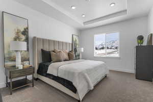 Bedroom with a mountain view, carpet floors, and a tray ceiling