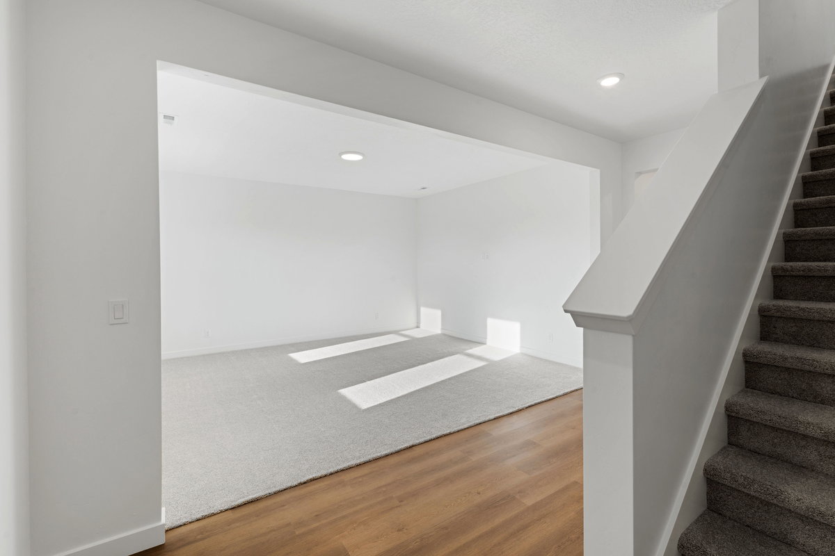Stairs featuring wood finished floors and recessed lighting