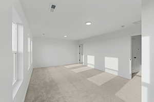 Spare room with light carpet and baseboards