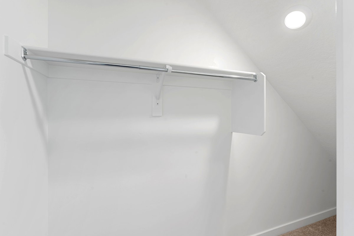 Spacious closet featuring vaulted ceiling and carpet