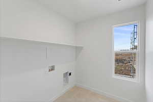 Washroom with hookup for a washing machine and hookup for an electric dryer