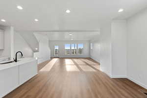 Unfurnished living room featuring light wood-type flooring and recessed lighting