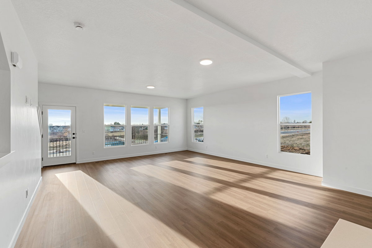 Empty room featuring light wood-style floors and recessed lighting