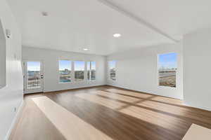 Empty room featuring light wood-style floors and recessed lighting