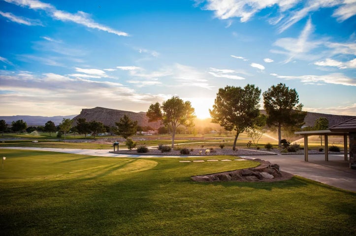Surrounding community with a yard and a mountain view