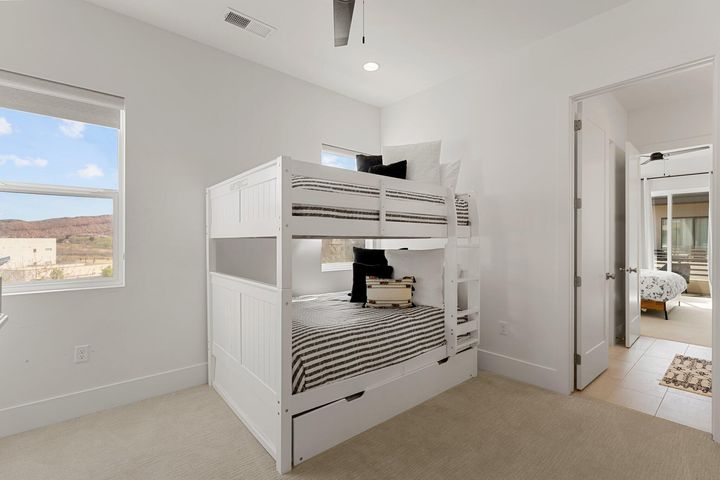 Unfurnished bedroom with light carpet and baseboards