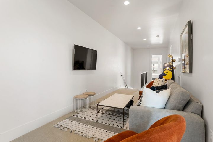 Carpeted living room featuring baseboards and recessed lighting