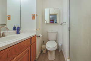 Bathroom featuring vanity, a shower stall, and light wood finished floors