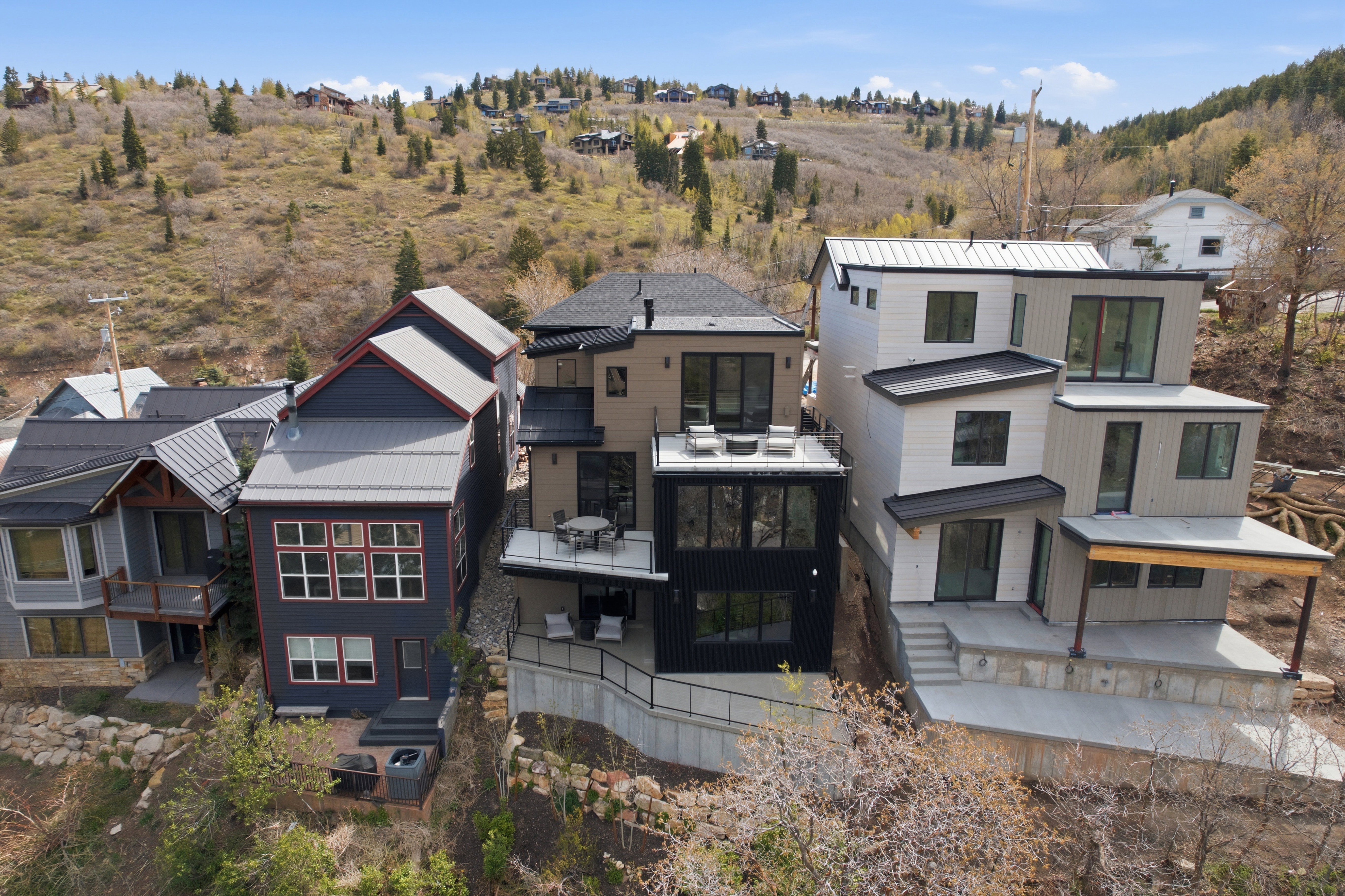 Modern multi-level residence with a tiered facade and multiple outdoor deck spaces