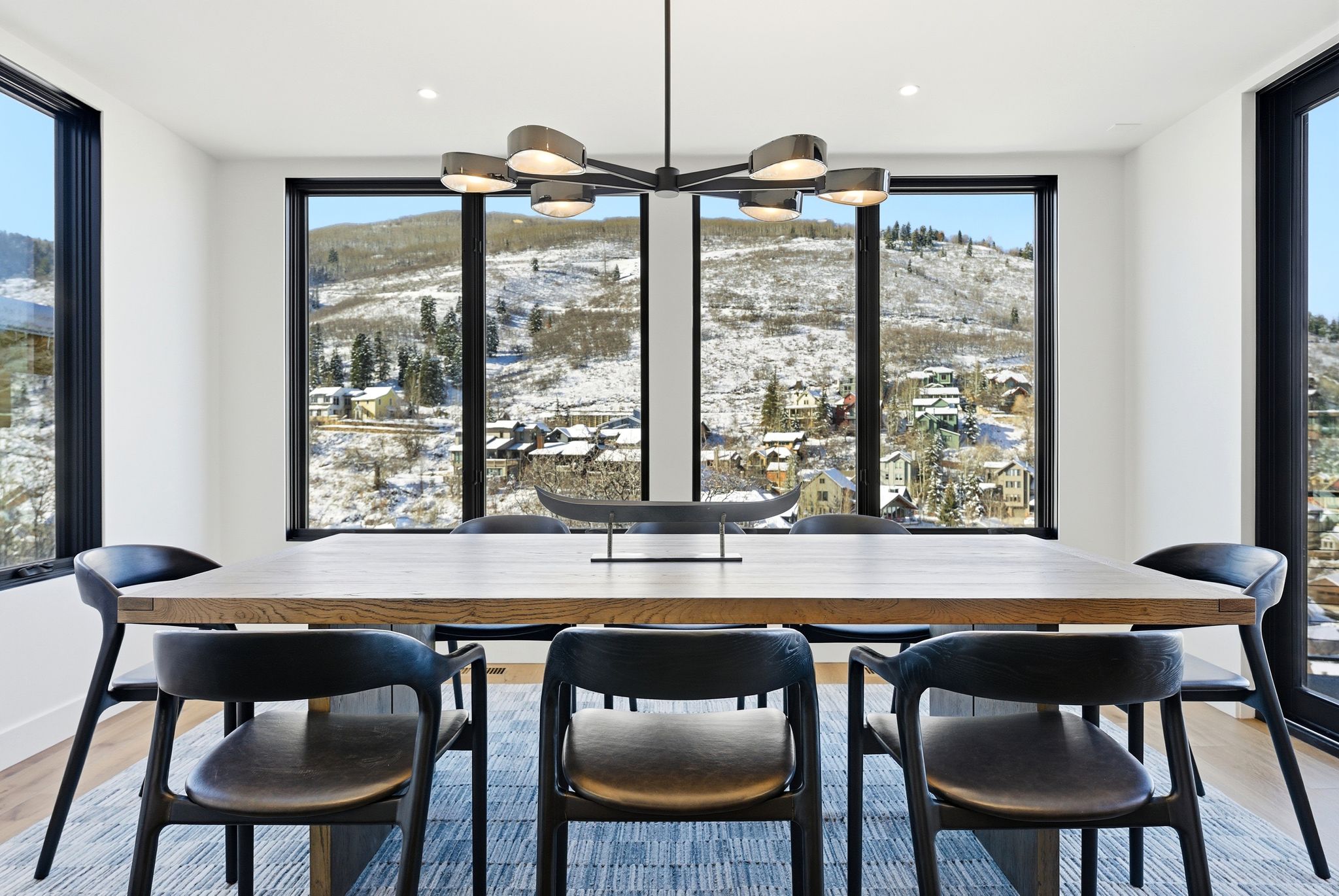 Dining space with light wood finished floors, a mountain view, and a chandelier