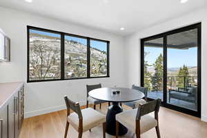 Dining space with a mountain view, light wood finished floors, and recessed lighting