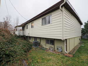 View of side of property featuring a lawn