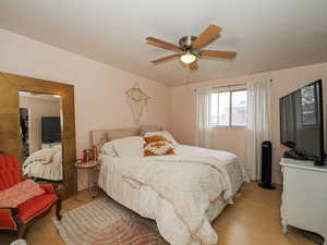 Bedroom with wood finished floors and ceiling fan
