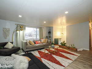 Living room with a chandelier and wood finished floors