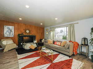Living room with wood finished floors and wooden walls