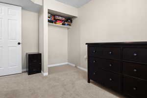 Spacious closet with light colored carpet