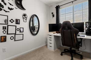 Office area with light colored carpet and baseboards