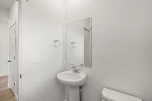 **DISCALIMER** Interior options may vary.Bathroom featuring toilet and wood finished floors