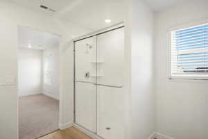 Bathroom featuring a stall shower and light wood-style floors
