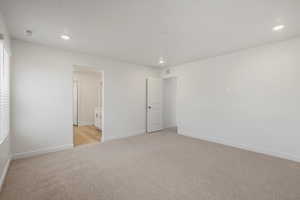 **DISCALIMER** Interior options may vary.Unfurnished bedroom featuring light colored carpet, recessed lighting, and ensuite bath