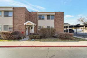 View of front of house with brick siding and stucco siding