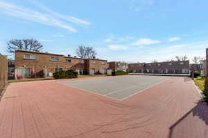View of tennis court with community basketball court