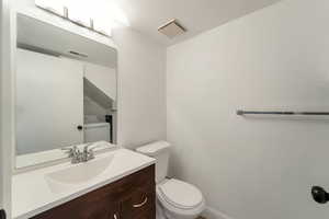 Half bathroom with vanity and washer / clothes dryer