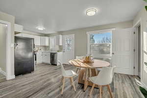 Dining area with light wood finished floors and baseboards