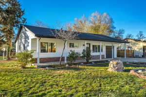 Ranch-style house featuring covered porch, an attached garage, and concrete driveway