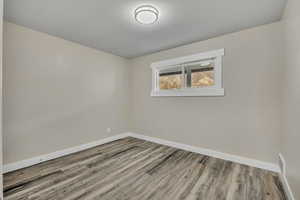 Unfurnished room with baseboards and light wood finished floors
