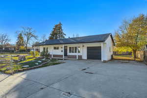 Single story home featuring covered porch, concrete driveway, an attached garage, and brick siding