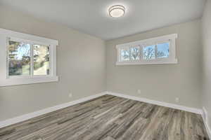 Empty room featuring wood finished floors and baseboards