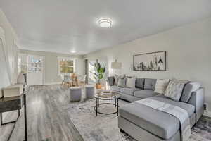 Living room with wood finished floors and baseboards