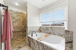 Full bathroom with a bath, a walk in shower, and recessed lighting