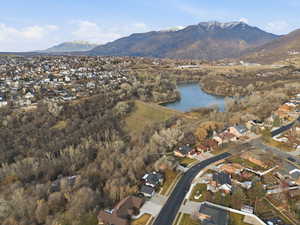 Aerial overview of property's location featuring nearby suburban area and a water and mountain view