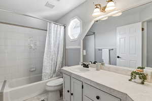 Full bath with vanity, shower / tub combo, a chandelier, and light tile patterned flooring