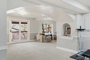 Exercise area featuring light carpet and healthy amount of natural light
