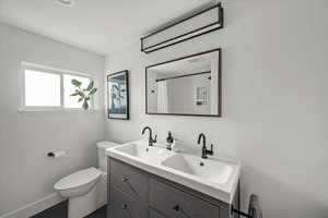 Full bath with double vanity and a shower with curtain