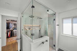 Primary suite featuring a full bathroom with double steam shower and a walk in closet