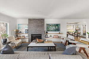 Living room featuring a large fireplace and wood finished floors