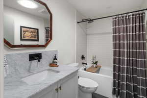 Bathroom with vanity and shower / bath combo