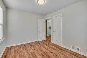 Unfurnished room featuring light wood-style flooring and baseboards