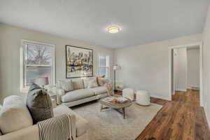 Living room with wood finished floors and a textured ceiling