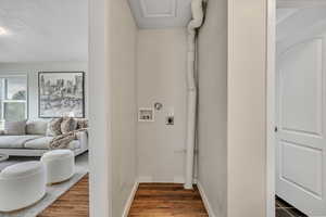 Washroom featuring dark wood-style floors, washer hookup, a textured ceiling, and electric dryer hookup